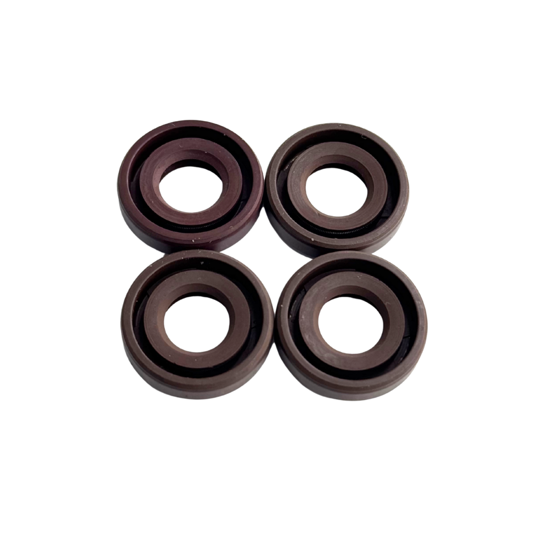 Four brown rubber washers on a white background