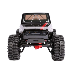 Model of a large off-road vehicle with oversized tires on a white background