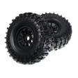Two black off-road tires with tread patterns on a white background