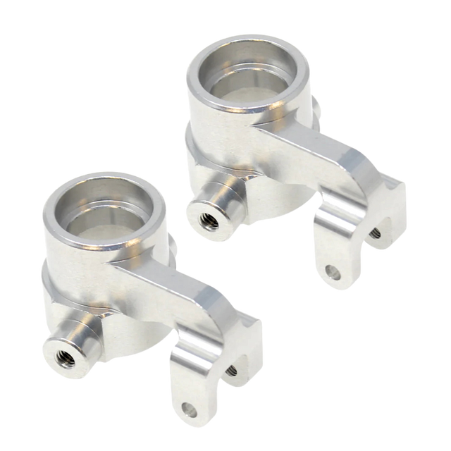 Two metallic metal suspension links on a white background