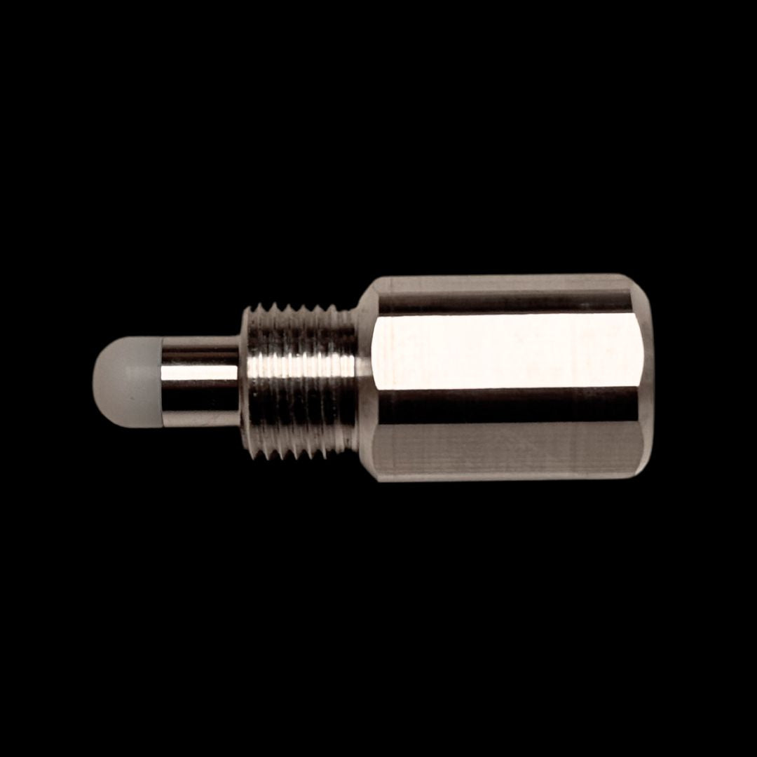 A silver-colored metal RC engine piston stopper against a black background.