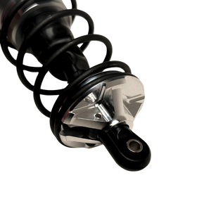 Taylor Losi 5IVE-T 3.0 raw silver billet shock perch fitted to a black shock with spring, side view showing the slot and spoke profile
