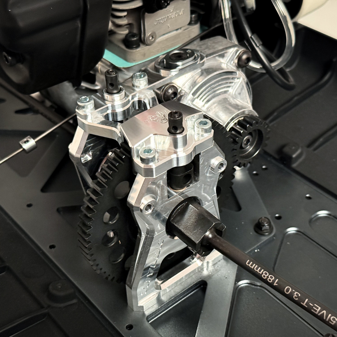 Taylor Losi 5ive-TG 3.0 raw silver billet centre diff mount fitted to a Losi 5ive-T with spur gear, pinion and engine visible