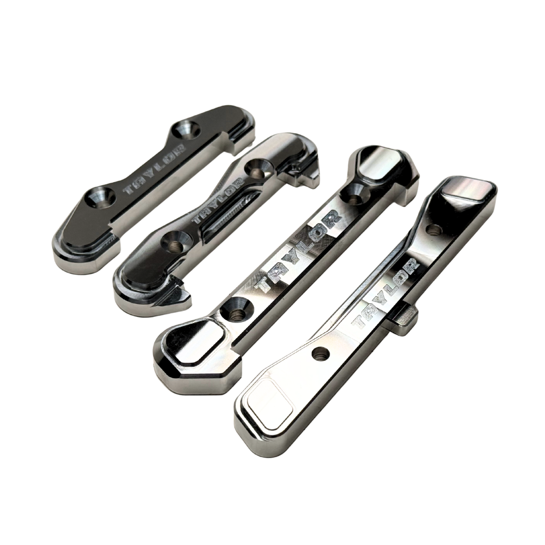 Taylor Losi 5T, 5IVE 2.0 and 5IVE-TG 3.0 raw silver billet 7075 hinge pin brace set, all four braces together showing the engraved Taylor logo and countersunk screw holes