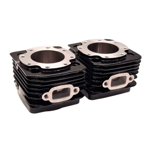Stack of black engine cylinder heads on a white background