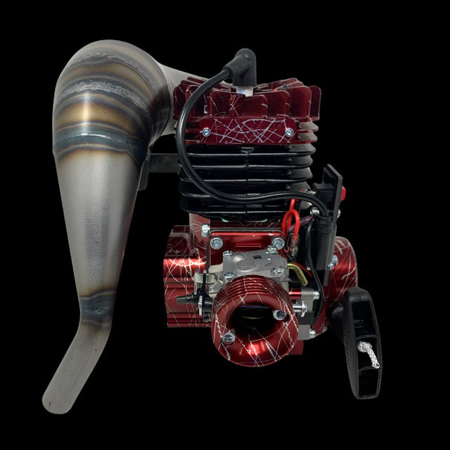 A high-performance TAYLOR 71cc billet reed engine package for a Kraken 4WD with a custom-made lightweight full circle crankshaft and custom high tension carbon-fibre petals. The engine is predominantly red with metallic and black components, and includes an external air-filter and a custom exhaust system.