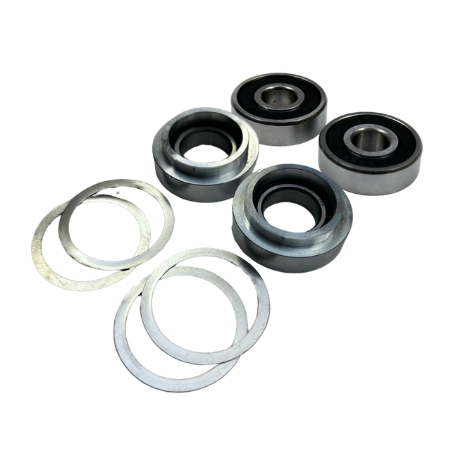Taylor RC Losi 5ive diff housing complete bearing rebuild kit, angled view showing two sealed bearings, two bearing carriers, and four shims