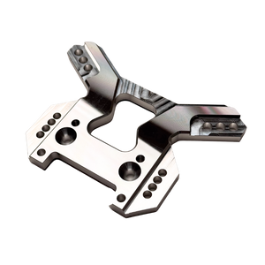 Taylor RC OUTLAW V4 front shock tower in raw silver, angled top-down view showing the full arm layout and central cutout