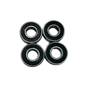 Four black and silver bearings on a white background