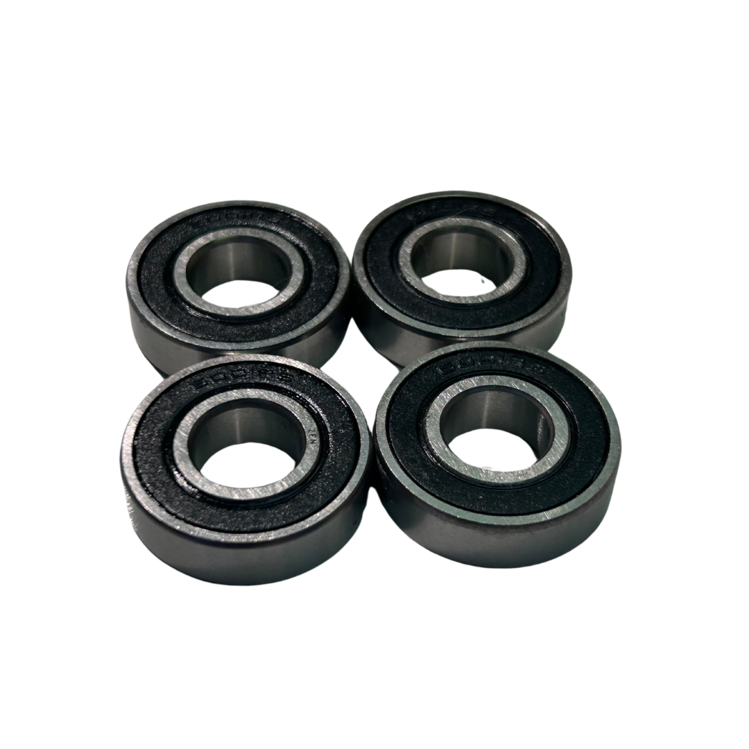 Four black bearings on a white background