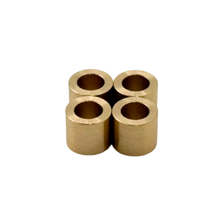 Four cylindrical brass bearings arranged in a cross formation on a white background.