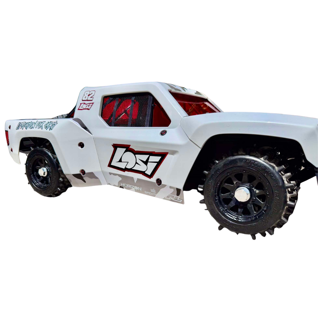 White off-road toy truck with black tires on a white background