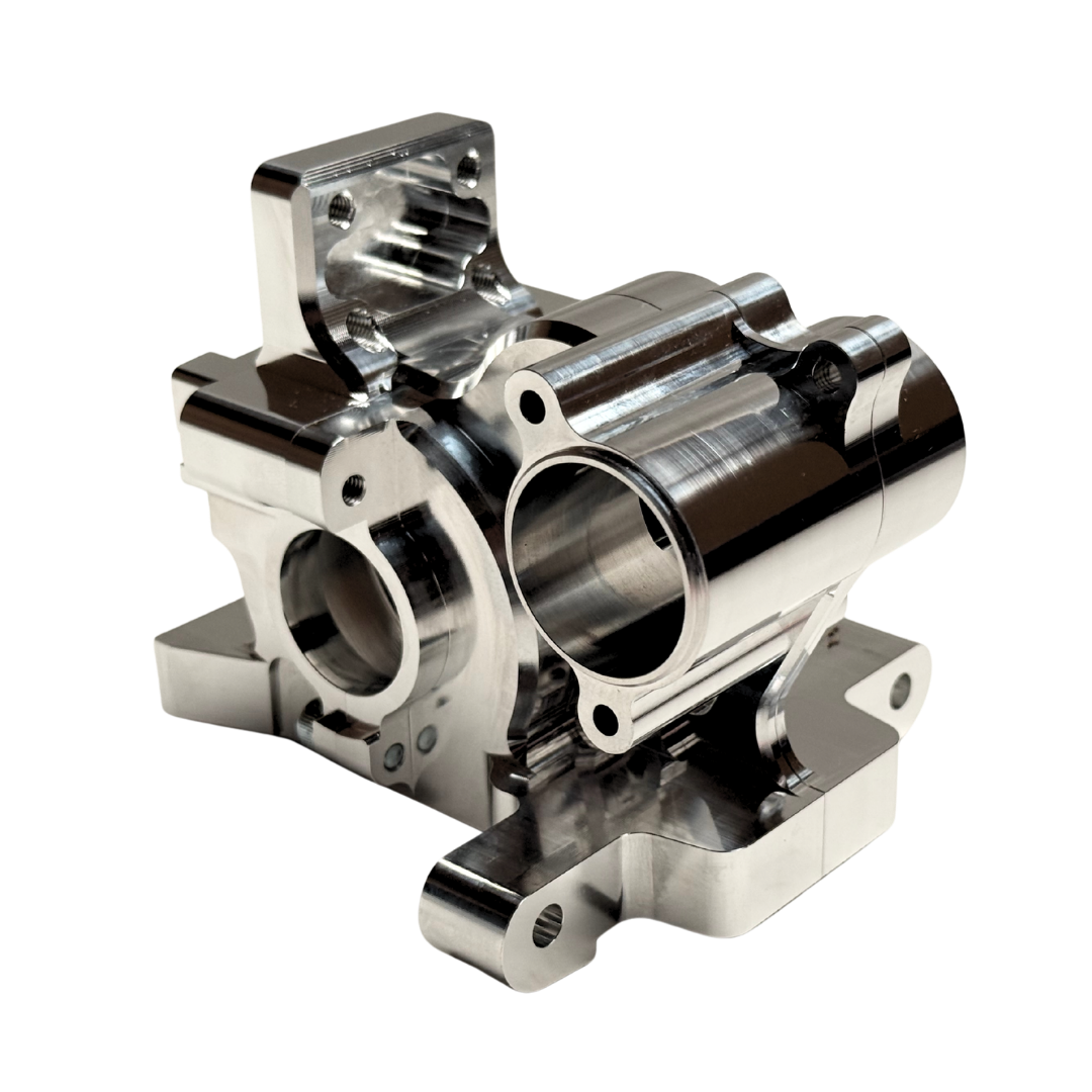 Taylor RC V2 billet Vesla transmission housing in raw silver, photographed from a rear angle with logo visible
