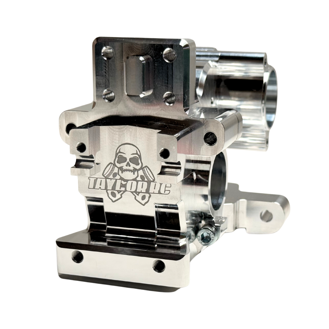 Close angle of the Taylor RC V2 billet Vesla transmission housing highlighting the engraved skull logo, raw silver finish