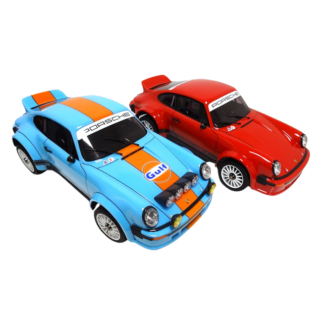 Two model cars, one blue and orange with Gulf livery, and one red with Porsche branding, on a white background.