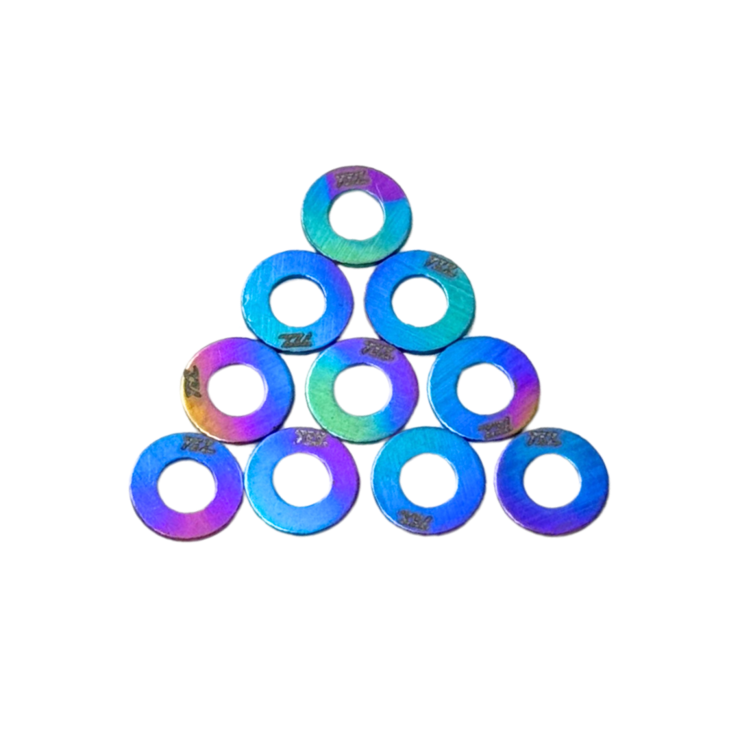 Iridescent washers stacked in a pyramid formation on a white background