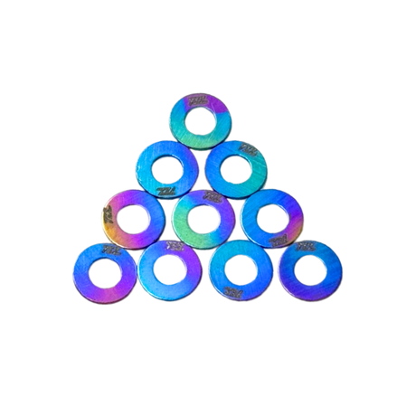 Iridescent washers stacked in a pyramid formation on a white background