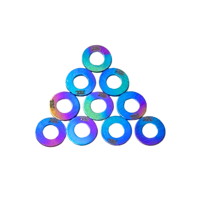 Iridescent washers stacked in a pyramid formation on a white background