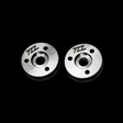 Two metal MCD shock pistons with TZZ logo on a black background