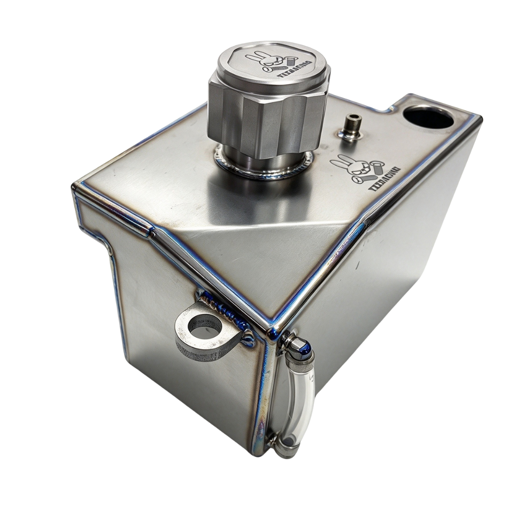 TZZ Racing titanium fuel tank for MCD, angled view showing the cap and mounting points
