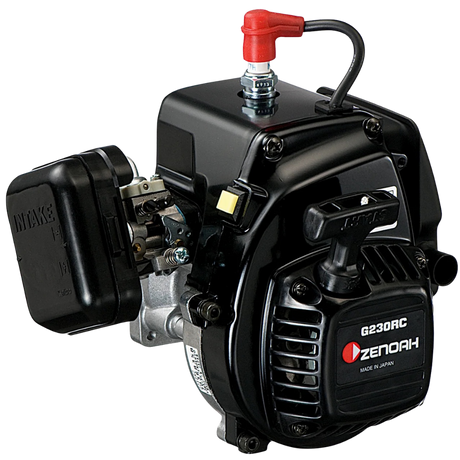A Zenoah G230RC 2-stroke gasoline engine with a black casing, silver metal components, a red fuel cap, and a black pull-start handle, shown on a solid white background.