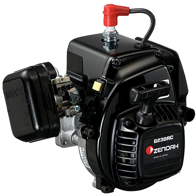 A Zenoah G230RC 2-stroke gasoline engine with a black casing, silver metal components, a red fuel cap, and a black pull-start handle, shown on a solid white background.